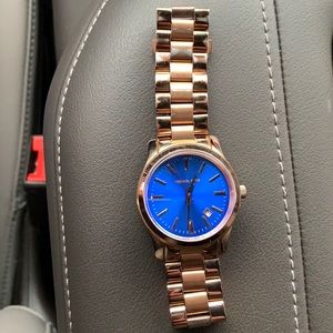 Michael Kors blue face watch.